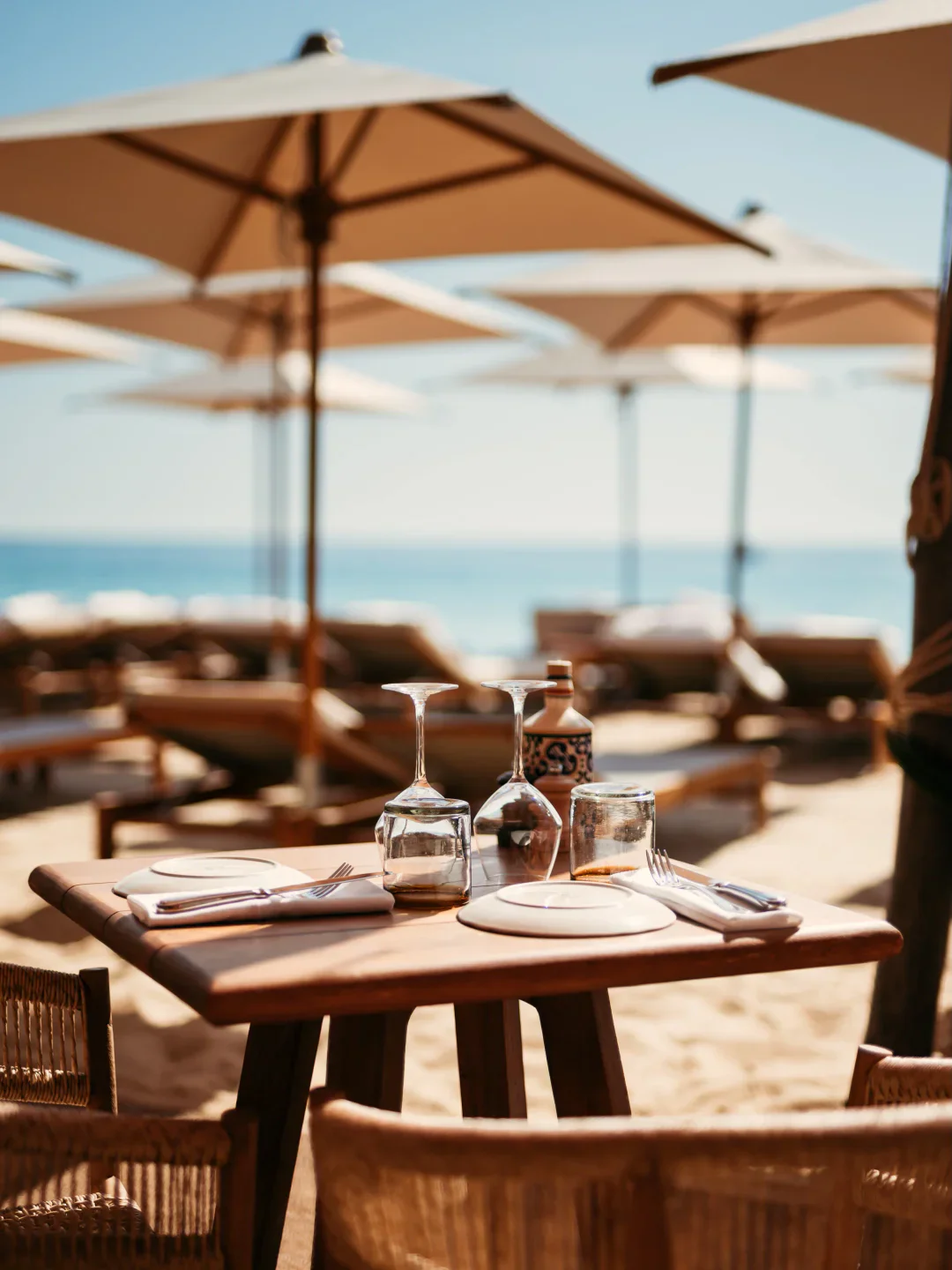 Casita restaurant in Saint-Tropez offers beachside dining with tables set on the sand under umbrellas.