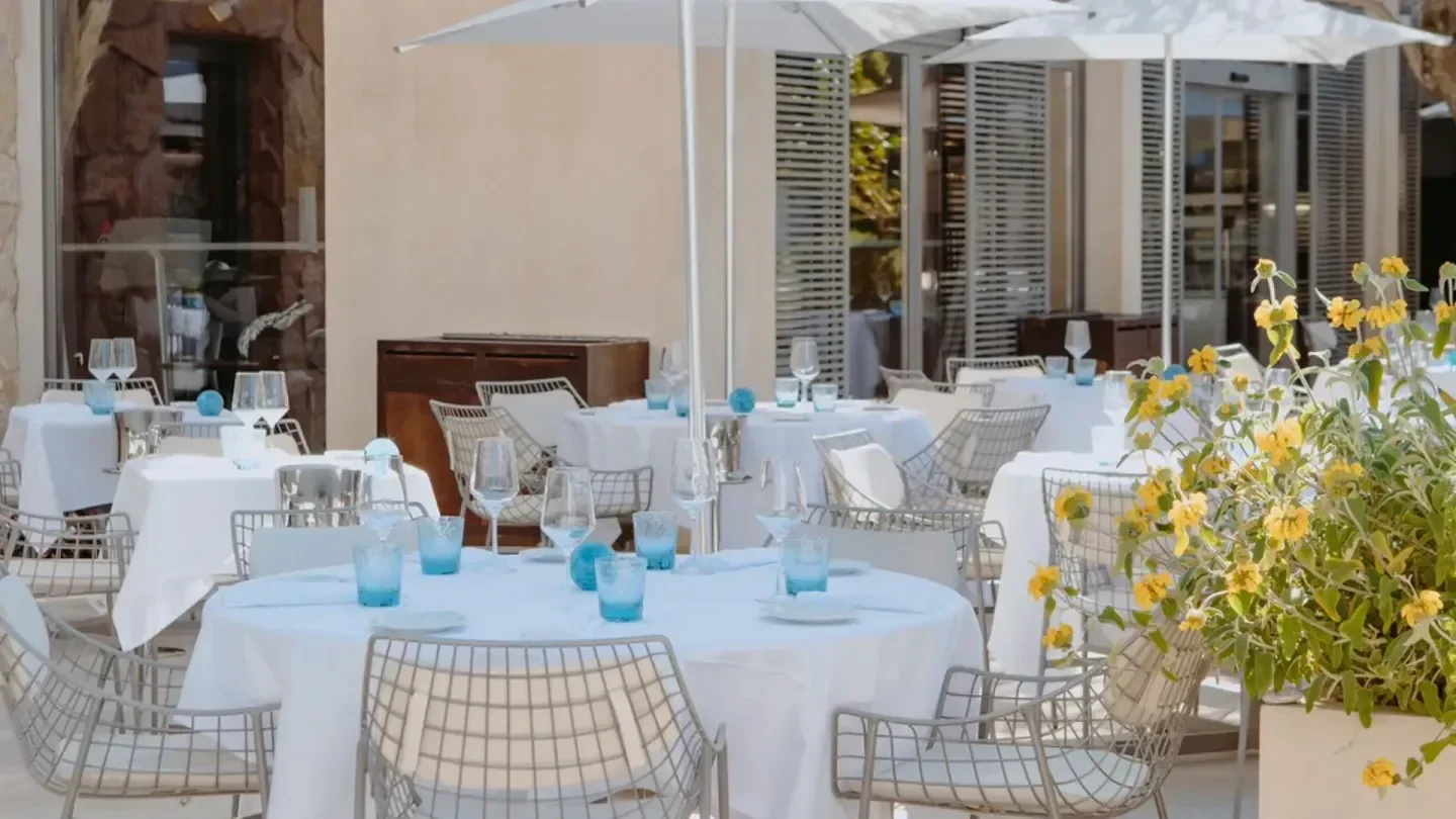 Outdoor dining at Colette restaurant in Saint-Tropez, featuring elegant table settings and decor