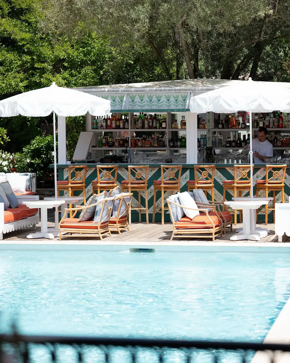GAIA restaurant bar area by the pool with bamboo chairs and umbrellas in the city