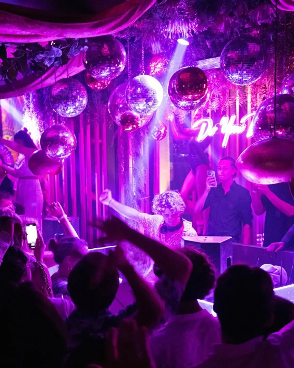 Energetic night at GAIO nightclub in Saint-Tropez, with disco balls and dancing crowd.