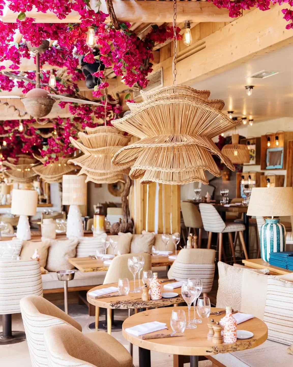 Elegant dining at La Petite Plage in Saint-Tropez, with stylish decor and floral accents.