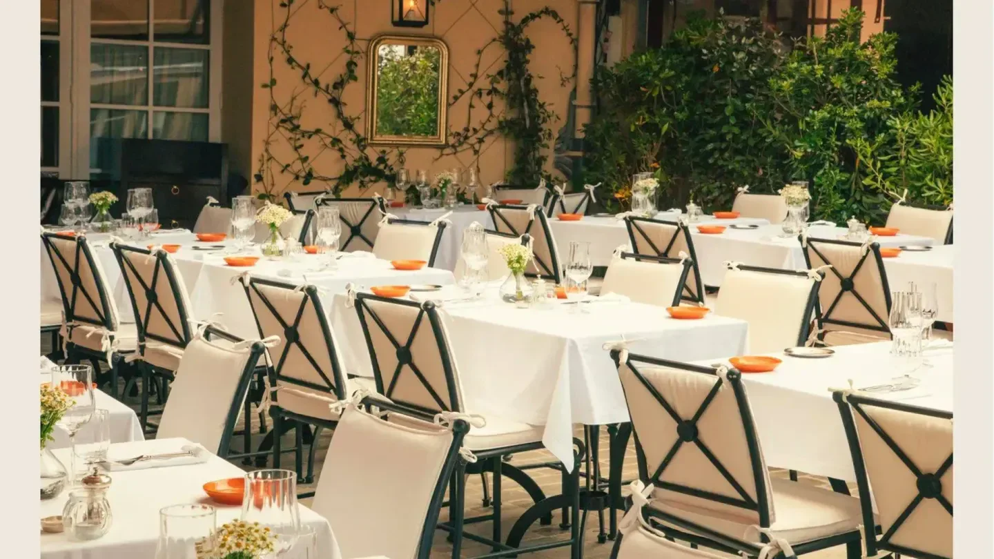 Elegant outdoor dining at La Ponche restaurant in Saint-Tropez, with tables set.