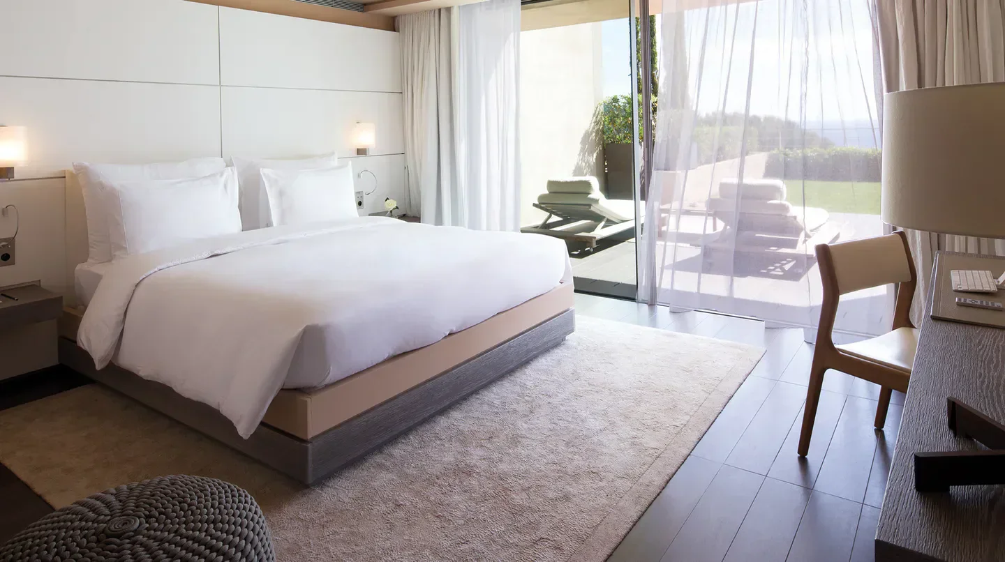 Luxury bedroom at La Réserve Ramatuelle in Saint-Tropez, with terrace and sea views.