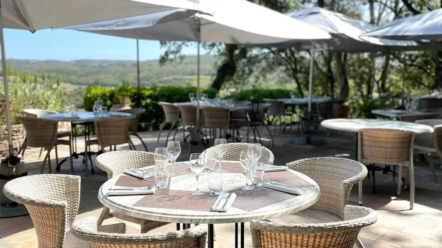 Outdoor dining at La Verdoyante in Saint-Tropez, showcasing scenic views and elegant setting.