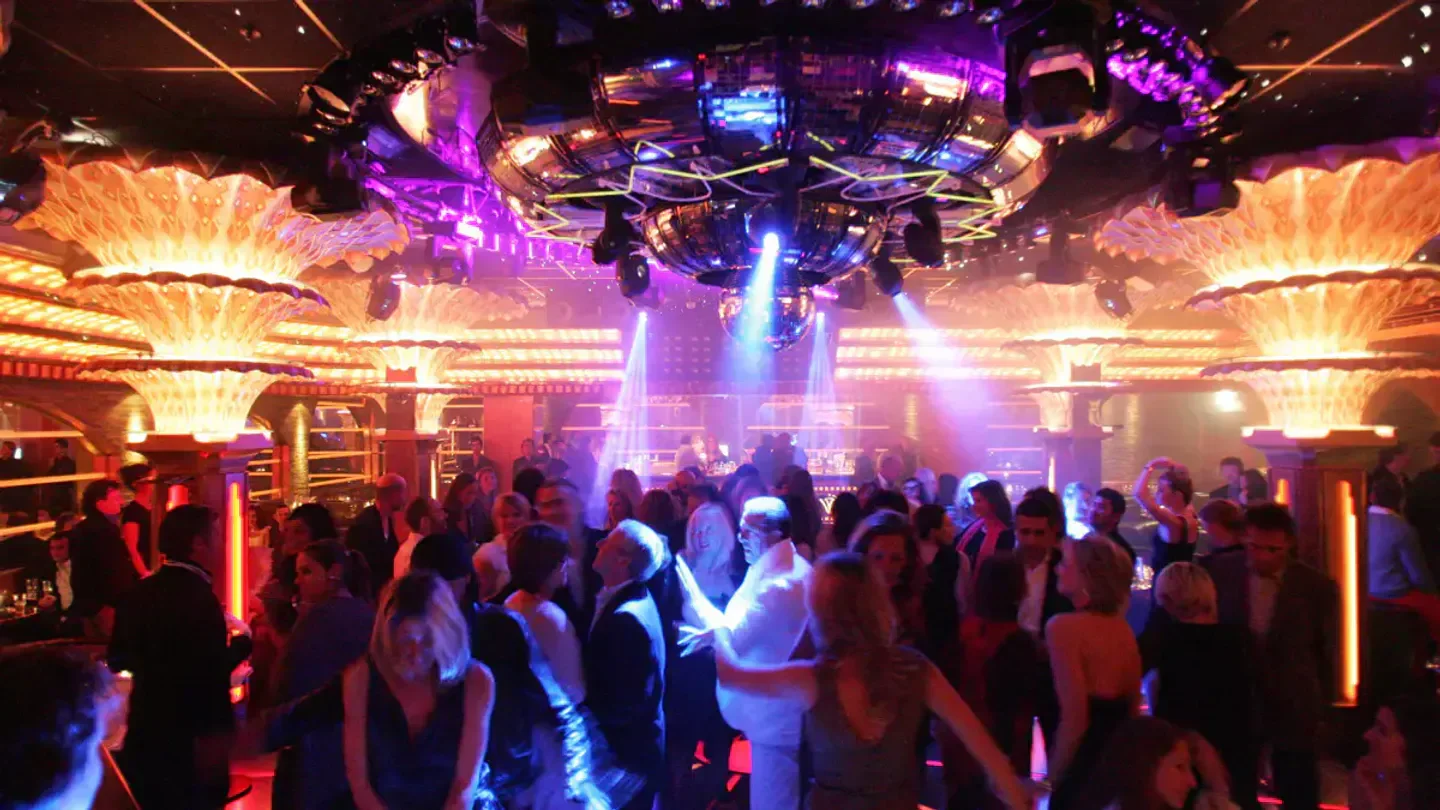 Inside Les Caves du Roy nightclub in Saint-Tropez, a lively dance floor and party