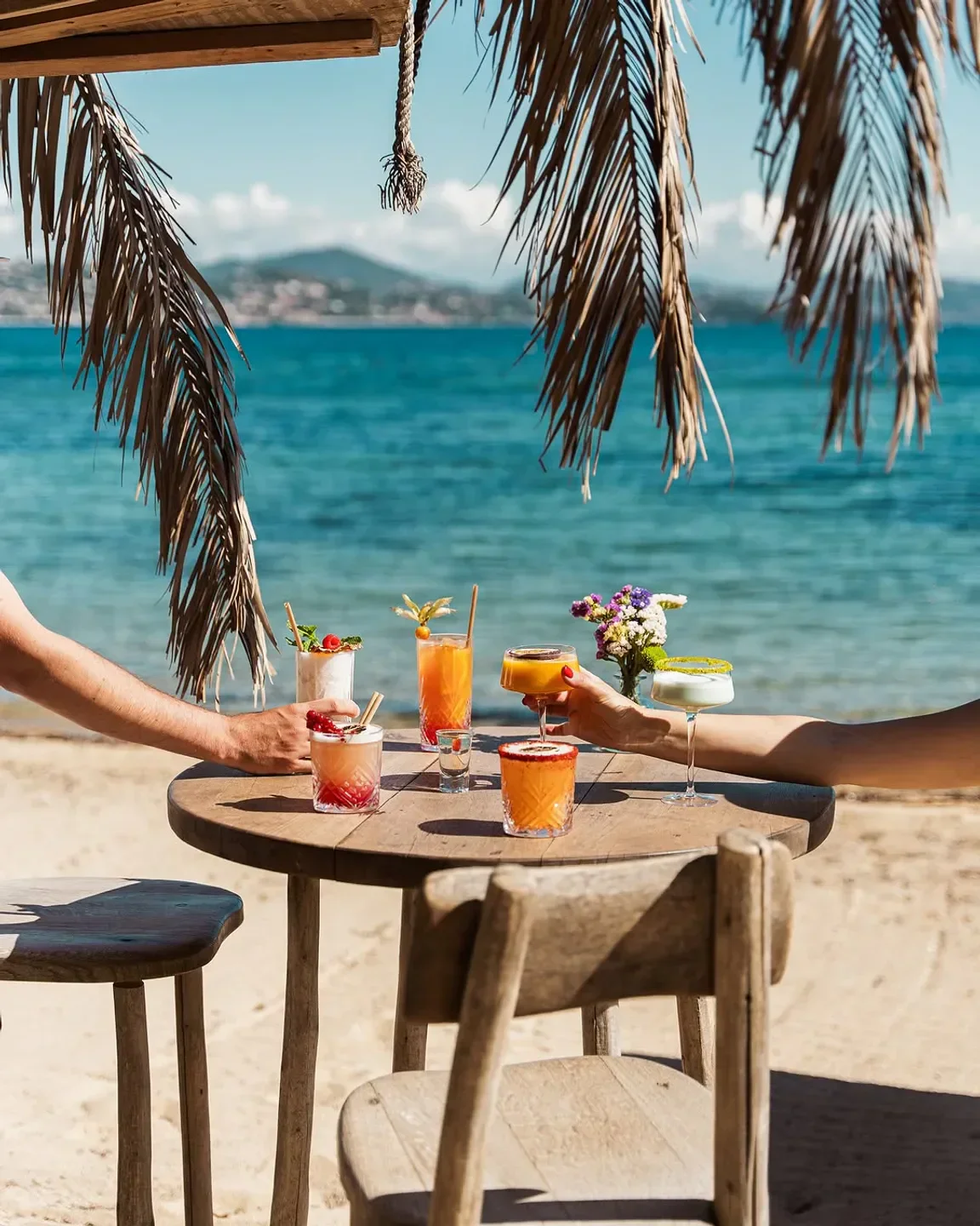 Cocktails at Les Graniers in Saint-Tropez. Beachside dining with ocean views and refreshing drinks.