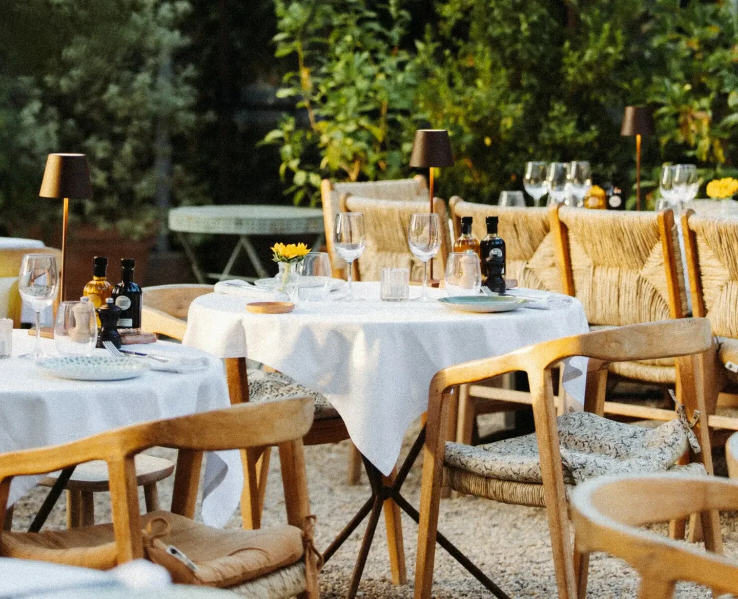 Outdoor dining at Les Moulins de Ramatuelle in Saint-Tropez, set for a beautiful evening.