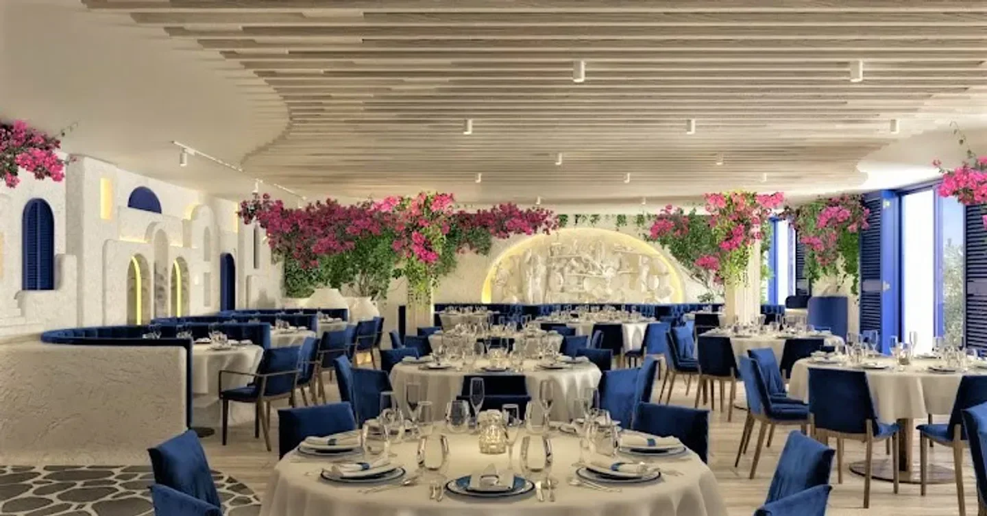 Elegant interior of Opa restaurant in Saint-Tropez, featuring Greek-inspired decor and tables.