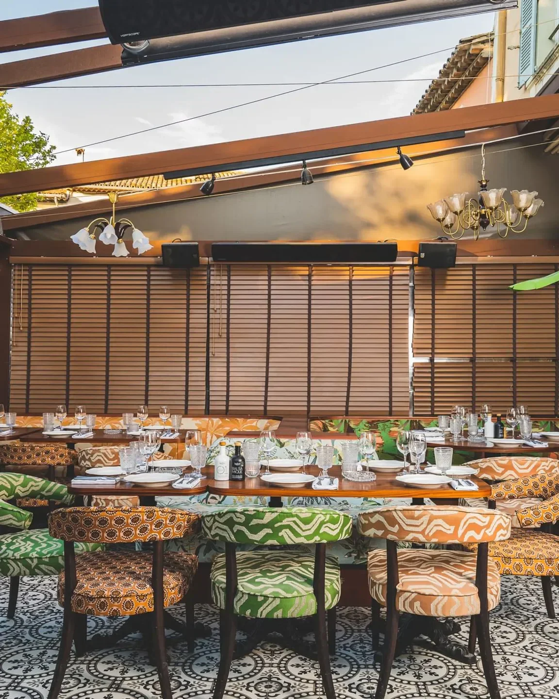 Outdoor dining at Pablo restaurant in Saint-Tropez, with patterned chairs and tables