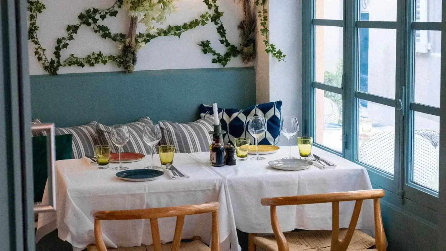 Cozy dining area at Zetta restaurant in Saint-Tropez, with a table set for a meal.